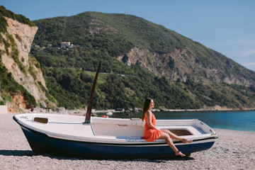woman sitting on the beach in boat