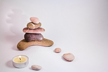balancing pebbles with candle