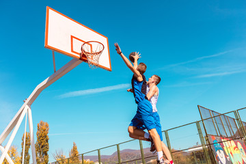 Young Basketball street player making slam dunk © FS-Stock