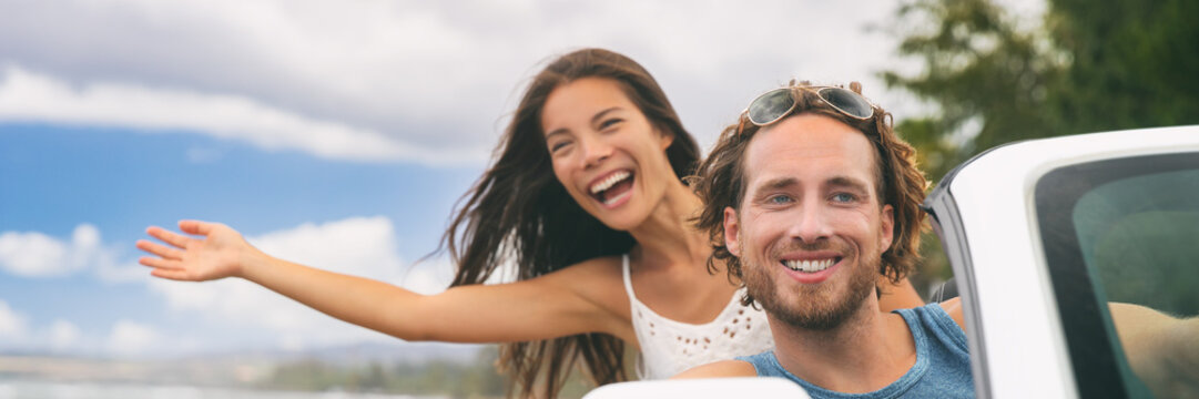 Car Road Trip Travel Fun Young Couple Driving On Summer Vacation Freedom Banner. Happy Free People In Convertible Cabriolet. Asian Woman Carefree With Open Arms Joyful. Friends Going On Road Trip.