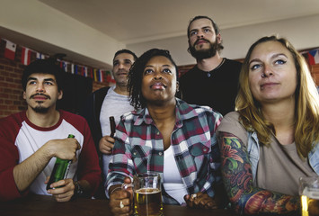 Frieds cheering sport at bar together
