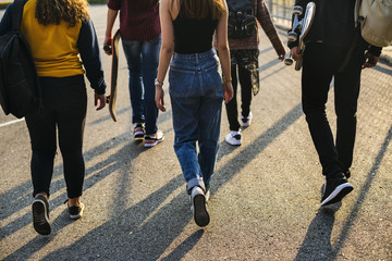 Rear view of group of school friends walking outdoors lifestyle - obrazy, fototapety, plakaty