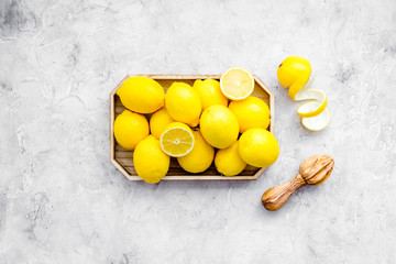 Ripe lemon fruit in tray on grey background top view copy space