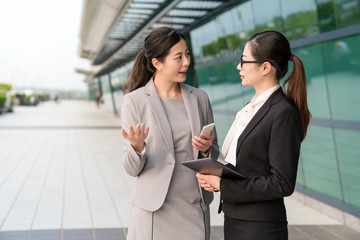 businesswomen talking outdoor.