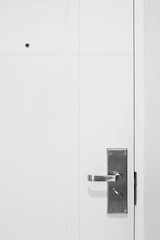 Naklejka premium White wooden door with handle, lock and peephole