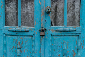A locker for two old blue doors in a village area in Moldova.