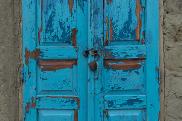 A locker for two old blue doors in a village area in Moldova