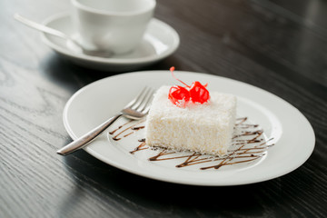 cake for the party on the table in room. cake covering with icing. party dish. vanilla cake