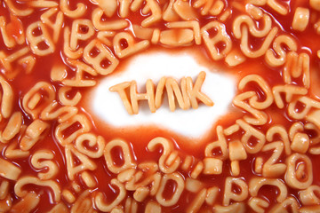 Think written in spaghetti pasta letters surrounded with jumbled letters.