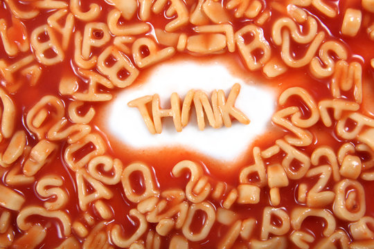 Think written in spaghetti pasta letters surrounded with jumbled letters.