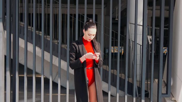 Sexy female dancer in Vogue and Waacking dance style dancing in the city with urban background.