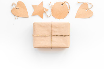 Parcel packaging box wrapped with craft paper with empty label mockups on whitebackground top view copy space