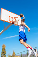 Young Basketball street player making slam dunk © FS-Stock