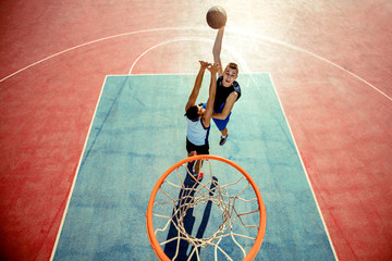 High angle view of basketball player dunking basketball in hoop
