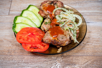 Fried meat with cucumber, tomato and onion. Delicious and mouth-watering barbecue.