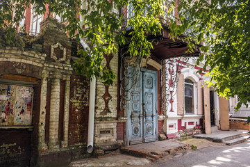 Facade of the 19th century crumbling house on Sovetskaya street in the center of Kurgan, Russia.