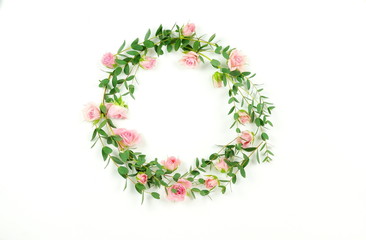 Flowers background. Wreath frame made of  pale pink roses  flowers and eucalyptus branches on a white background. Flat lay. top view. copy space