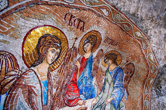 close up view on holy mosaic icons on a rock in Montenegro.  The Monastery of Ostrog is a popular place for pilgrims from many countries.