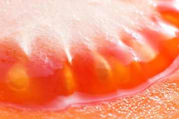 Sliced tomato close-up macro photo.