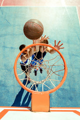High angle view of basketball player dunking basketball in hoop