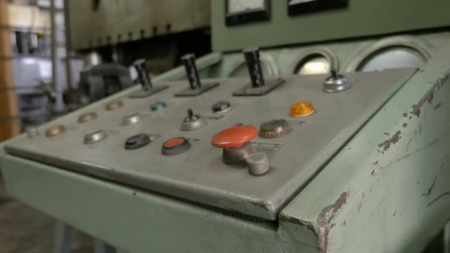 Pressing the red emergency button on the panel. Old control panel.
