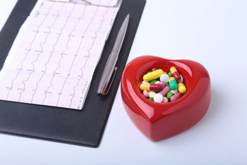 RX prescription, Red heart, asorted pils and a stethoscope on white background