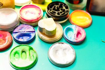 Different makeup cosmetics on brown wooden table
