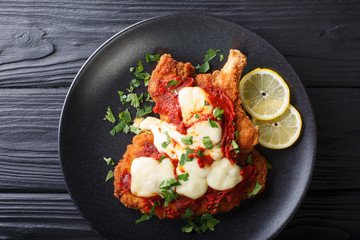 La milanesa napolitana - homemade veal cutlet with mozzarella cheese, lemon and tomato sauce...