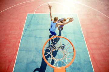 High angle view of basketball player dunking basketball in hoop