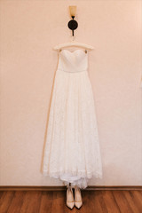 view of wedding dress is hanging awaiting  ceremony