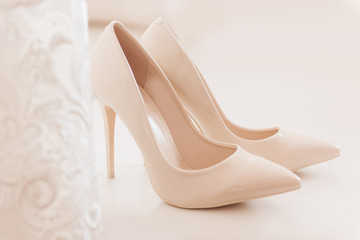 Womens wedding shoes on svetlom the background, the fees of the bride, selective focus