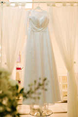 view of wedding dress is hanging awaiting  ceremony