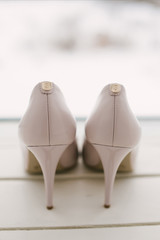 Womens wedding shoes on svetlom the background, the fees of the bride, selective focus