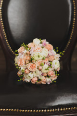 Bridal morning details. Wedding bouquet of orange, beige and pink flowers with succulent