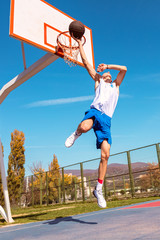 Young Basketball street player making slam dunk © FS-Stock