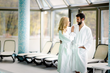 Beautiful cheerful couple relaxing in spa center