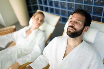 Handsome man and beautiful woman relaxing in spa