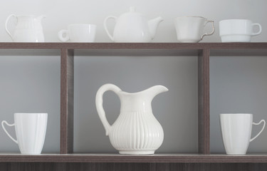 white kitchenware on wooden shelf