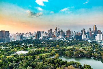 Naklejka premium Cityscape Bangkok downtown at Twilight, from the top of tower, Panorama view. and Natural park and many building.