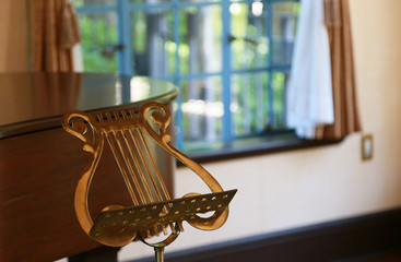 Metal music stand by the window of the room