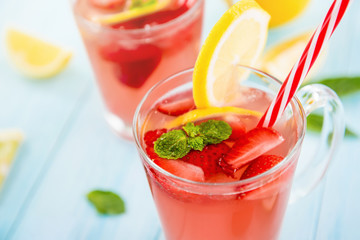 Colorful refreshing drinks for summer, cold sweet and sour strawberry lemonade juice in the glasses