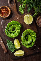 toast with avocado roses on wooden cutting board
