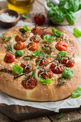 italian bread focaccia with tomatoes, basil and sea salt