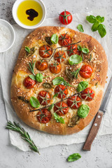 italian bread focaccia with tomatoes, basil and sea salt