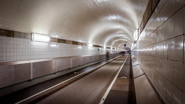 Timelapse of people walking in historic tunnel under river Elbe in Hamburg, Germany