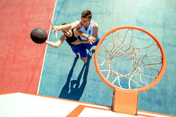 High angle view of basketball player dunking basketball in hoop