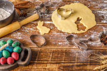 Still-life on a wooden background. Dough for biscuits and figured molds on it.