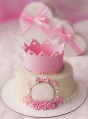Pink cake with crown and gifts in heart box for pretty girl birthday party