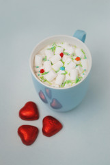 Hot Coccoa or Chocolate with Marshmallows Red Heart Shape Chocolate on Blue Background. Toned. Hot Drinks Concept. Soft Light.