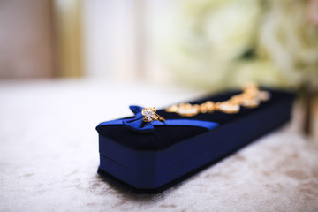 Jewelery with gold diamonds, rings and bracelets in gold and silver with sapphires and rubies. Selective focus.